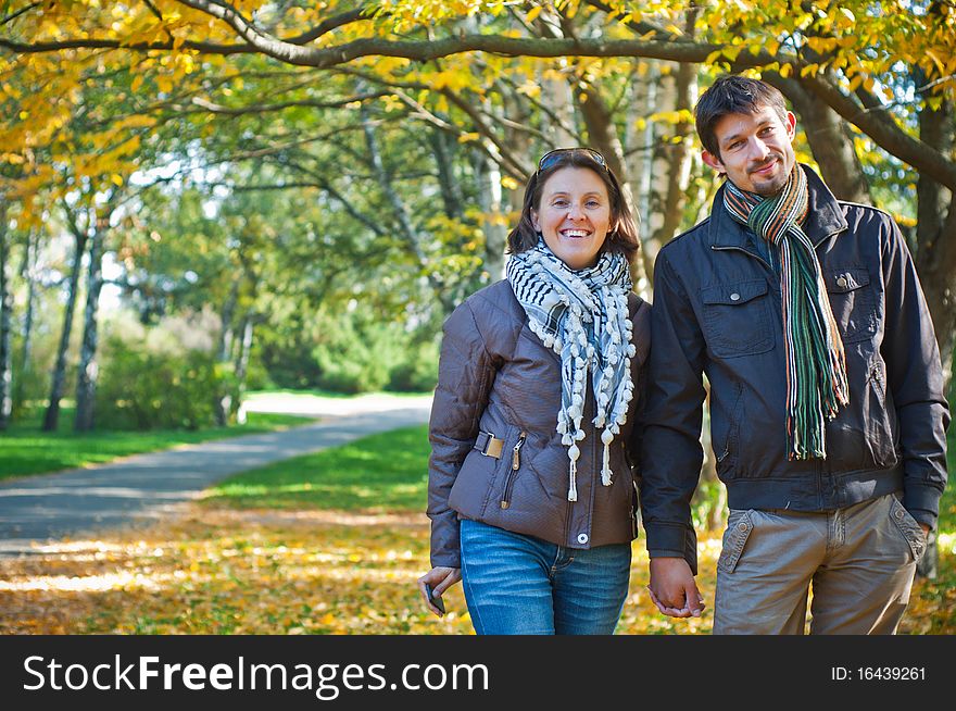 Romantic young beautiful couple on autumn walk