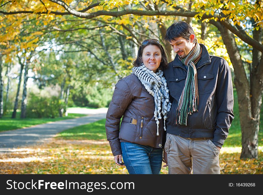 Romantic young beautiful couple on autumn walk