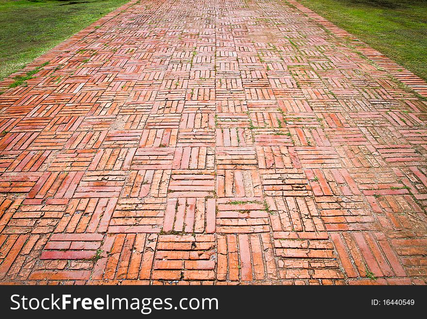 Vintage brick pathway on the green field