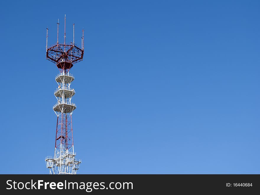 Telecommunication radio television tower high on a blue background sky. Telecommunication radio television tower high on a blue background sky