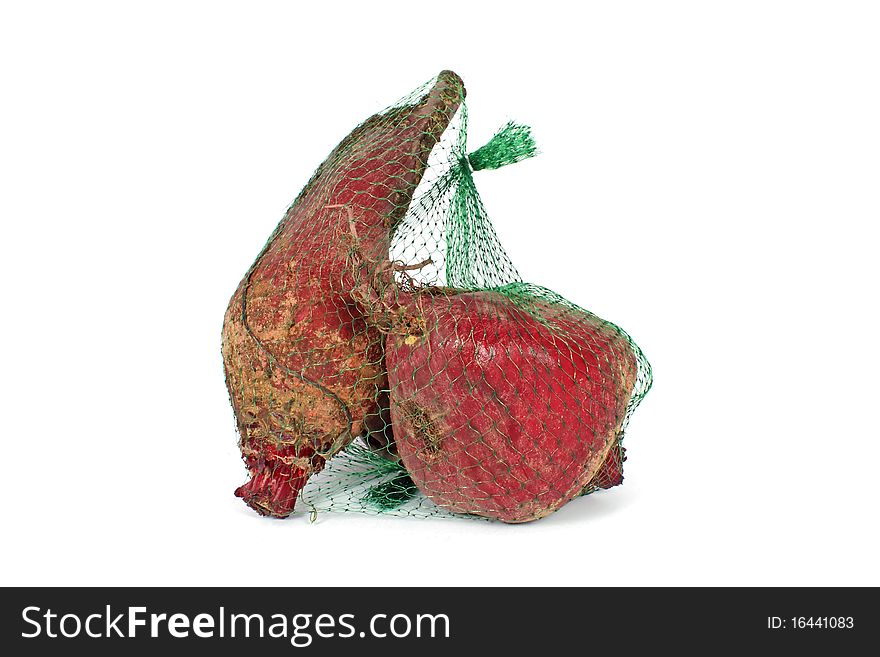 Red beet in plastic net isolated on white