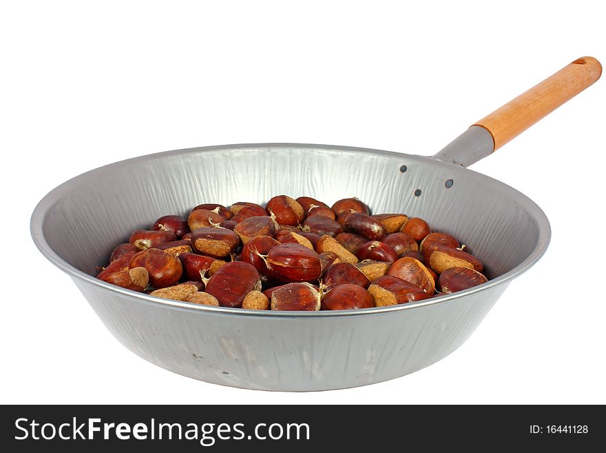 Raw chestnuts in a pan isolated on white