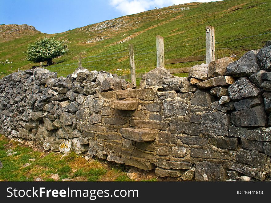 Close up view of a Peak District stone wall with a stile