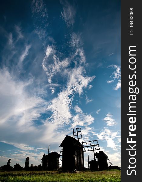 Landscape with a windmill against the blue sky