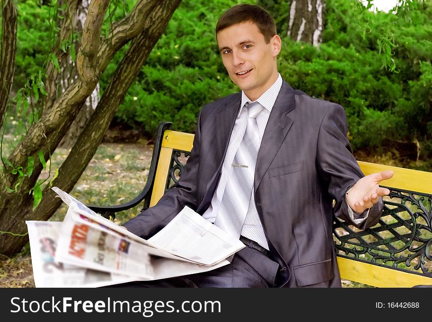 Young businessman reading a newspaper