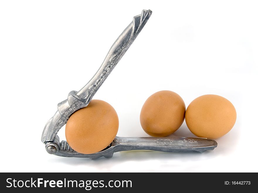 Nutcracker and eggs on white background