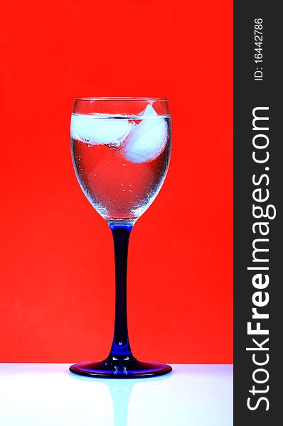 White wine glass with red background.