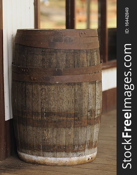 A barrel standing in front of a saloon