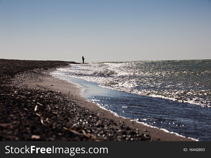 The fisherman fishes on the sea