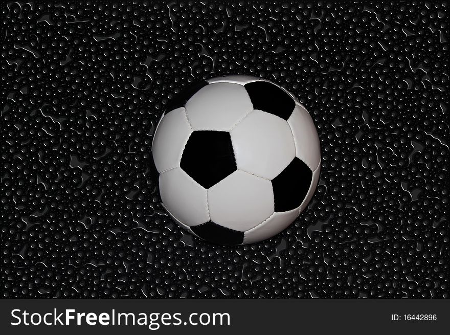 Soccer ball on wet surface. Soccer ball on wet surface.