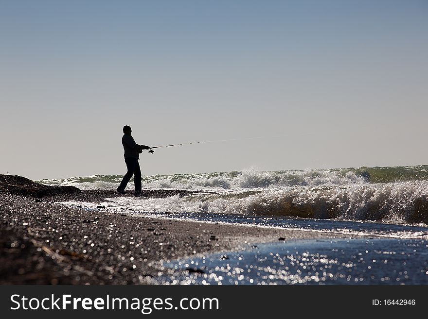 The fisherman fishes on the sea