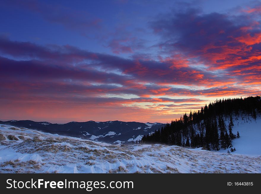 Winter landscape with mountains under evening sky with clouds. Winter landscape with mountains under evening sky with clouds