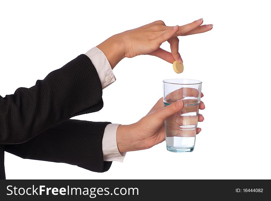 Businesswoman throws a pill from headache to the glass with water. Businesswoman throws a pill from headache to the glass with water