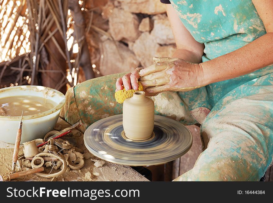 Close up of the hands of a potter creating a jug