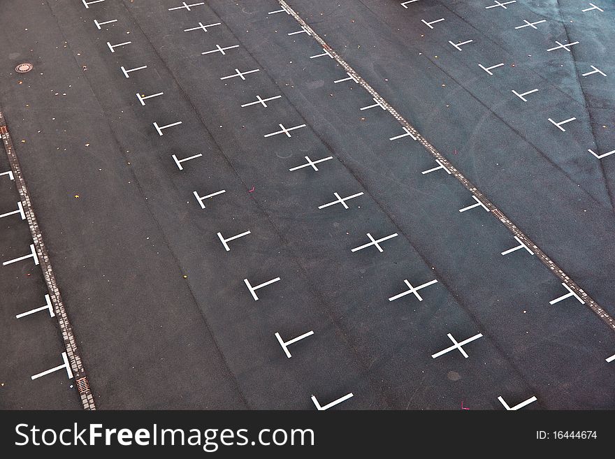 Marked parking lot without cars with crosses