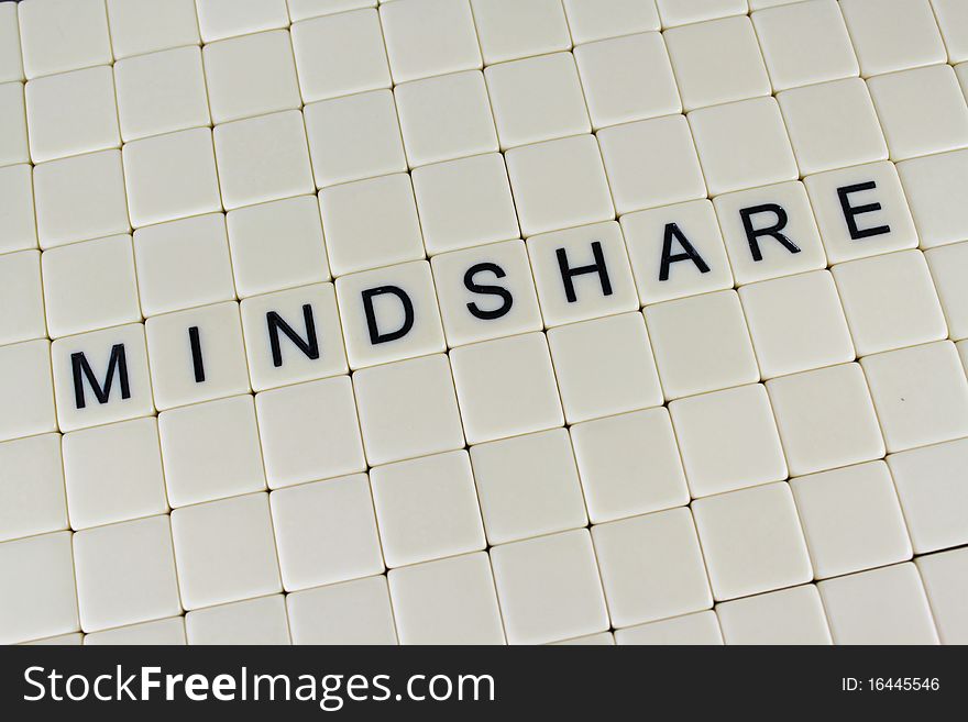 The word 'MIndshare' in tiles surrounded by blank tiles.