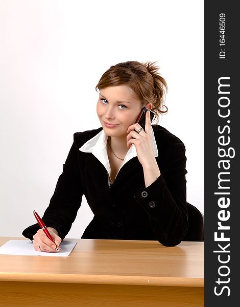 Businesswoman working at a desk, isolated on a white background