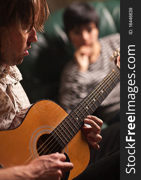 Musician Plays His Guitar As Friend Listens