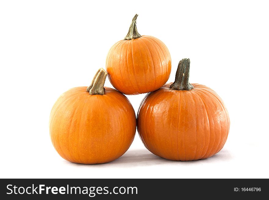 Three pumpkins stacked with a white background. Three pumpkins stacked with a white background.