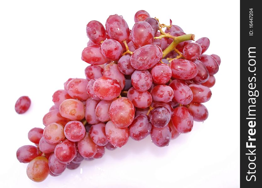Bunch of red seedless grapes freshly rinsed with water droplets visible. Bunch of red seedless grapes freshly rinsed with water droplets visible