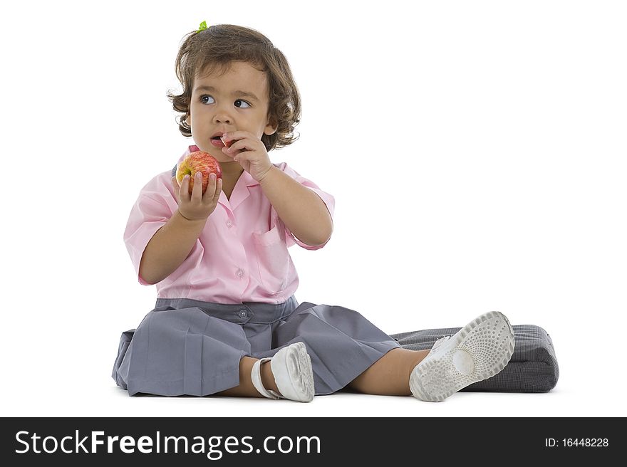 Cute little girl with an apple isolated on white background