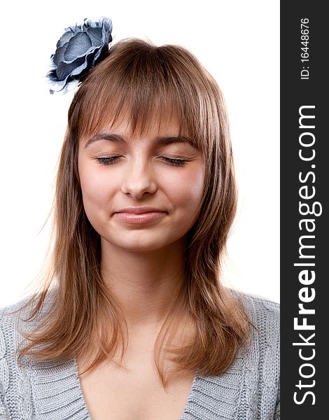 Portrait of the young girl with closed eye on white background