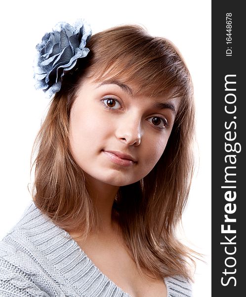 Portrait of the young girl in flower in hair on white background