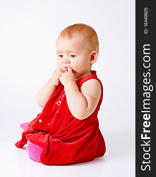 Little girl in red dress on white background