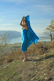 A Young Girl In A Blue Dress Dancing On A Mountain Stock Image A Young Girl In A Blue Dress Dancing On A Mountain Stock Image