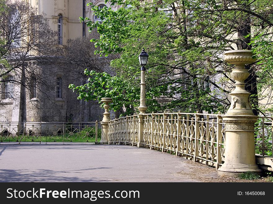 Asphalt road across the bridge in a city park in Budapest