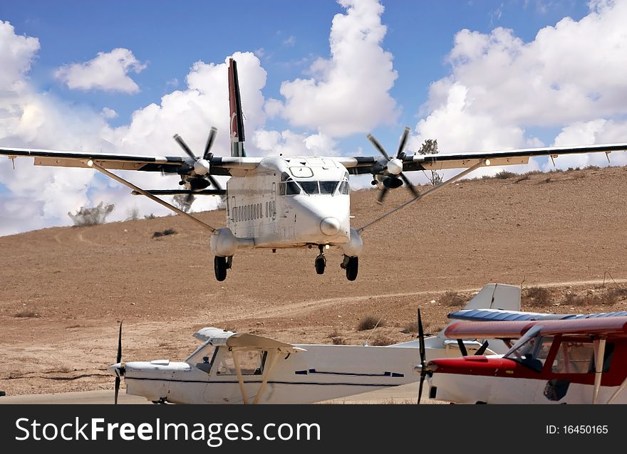 Airplane with propellers landing on a desert airport. Airplane with propellers landing on a desert airport