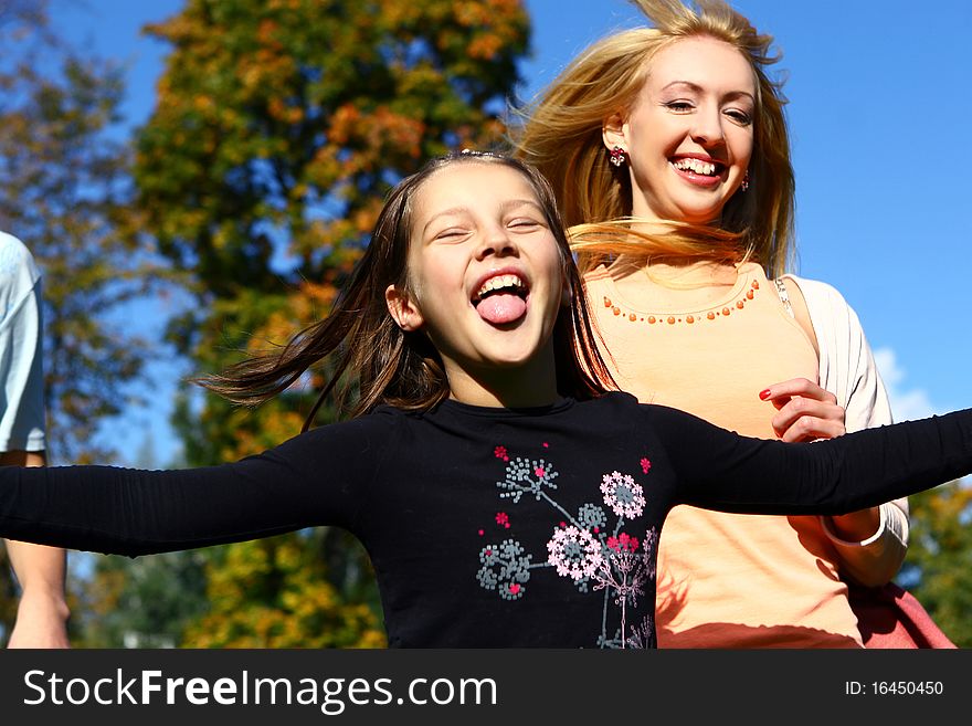 Two happy sisters have fun in park