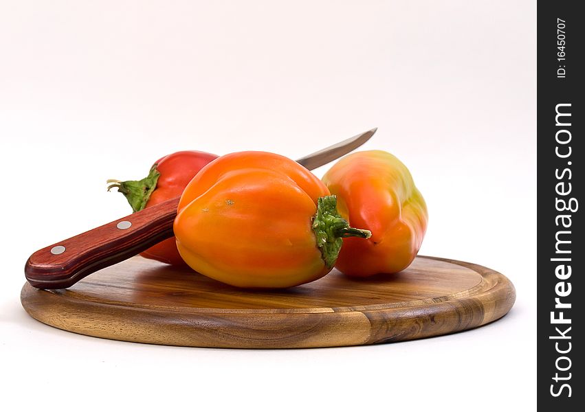 Colorful Paprikas On Wooden Kitchen Board