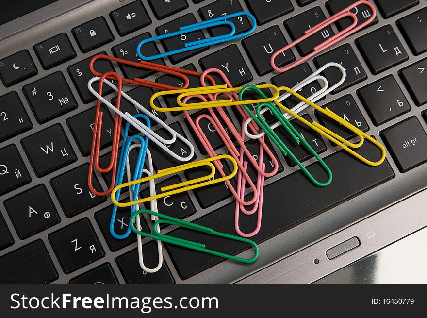 Several Paper Clips And Laptop