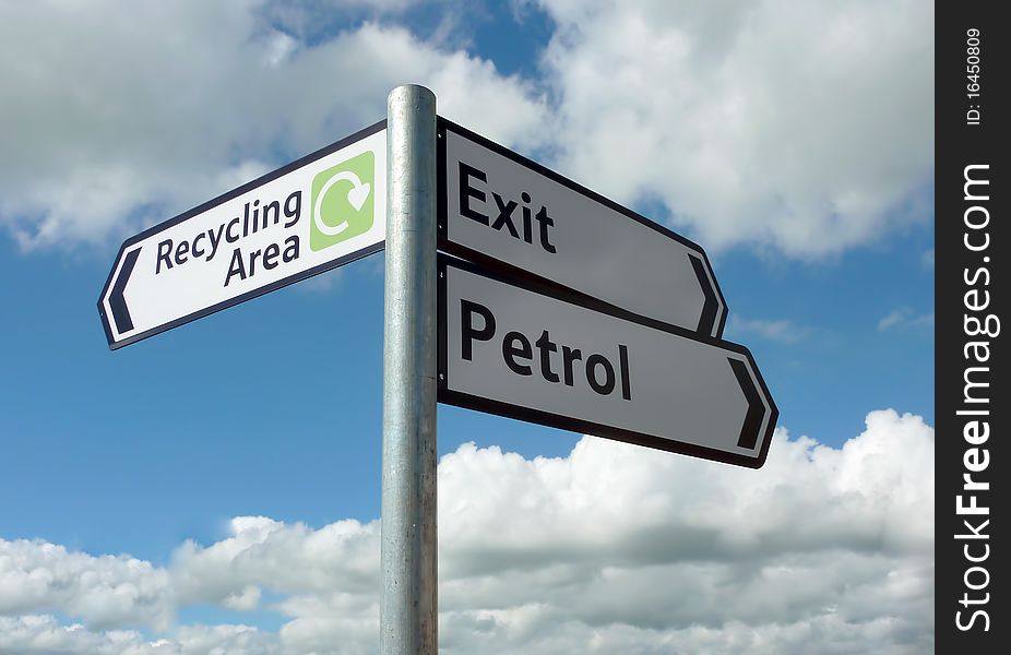 Close up of direction sign against blue cloudy sky