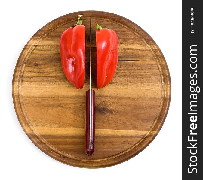 Red pepper on kitchen board with knife