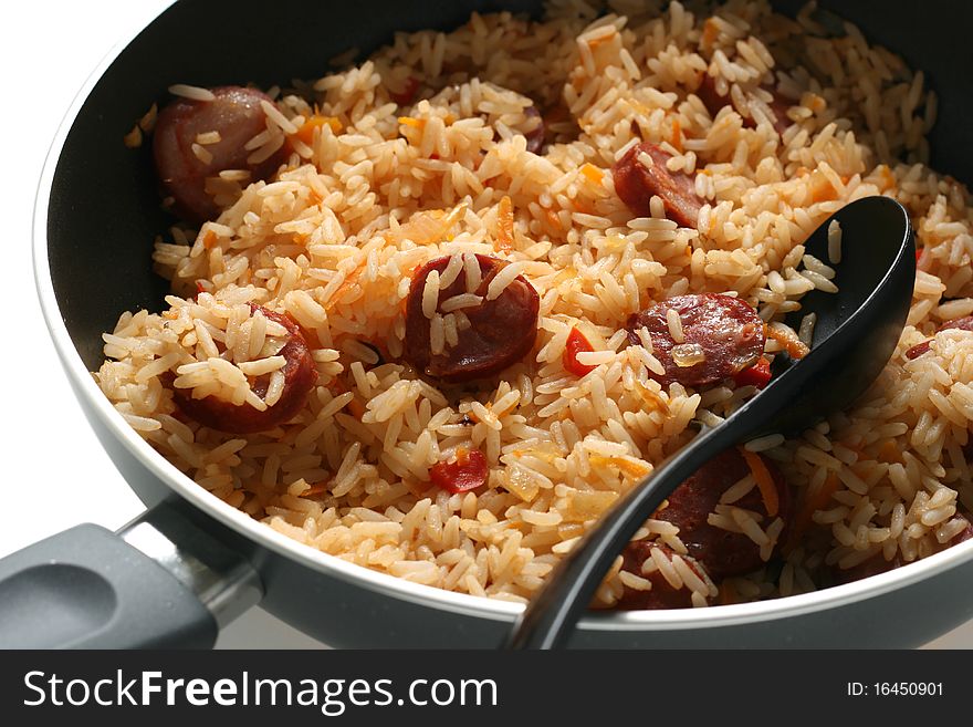 Fried rice with sausages on fried pan