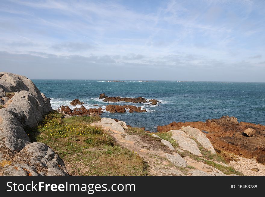 The rocky shores of the coastline at Les Grandes Rocques, Guernsey