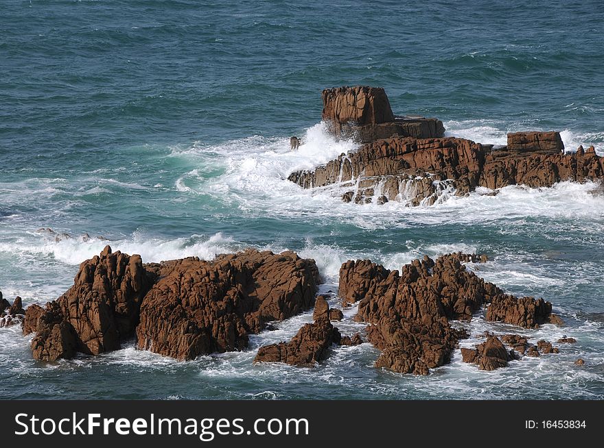 The rocky shores of the coastline at Les Grandes Rocques, Guernsey. The rocky shores of the coastline at Les Grandes Rocques, Guernsey