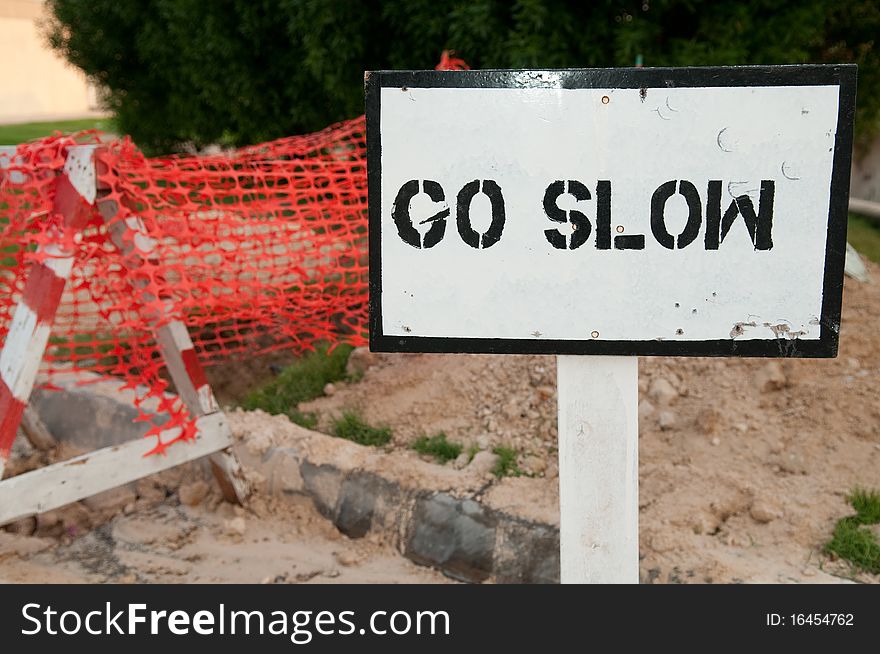 A warning sign in the front of a construction site. A warning sign in the front of a construction site