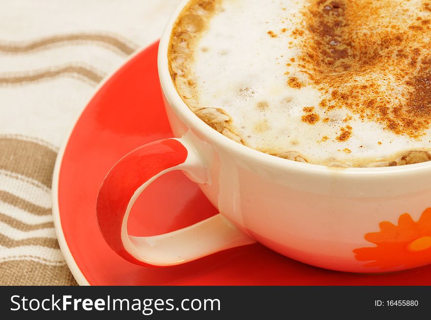 Cappucino with cinnamon in a colorful cup. Cappucino with cinnamon in a colorful cup