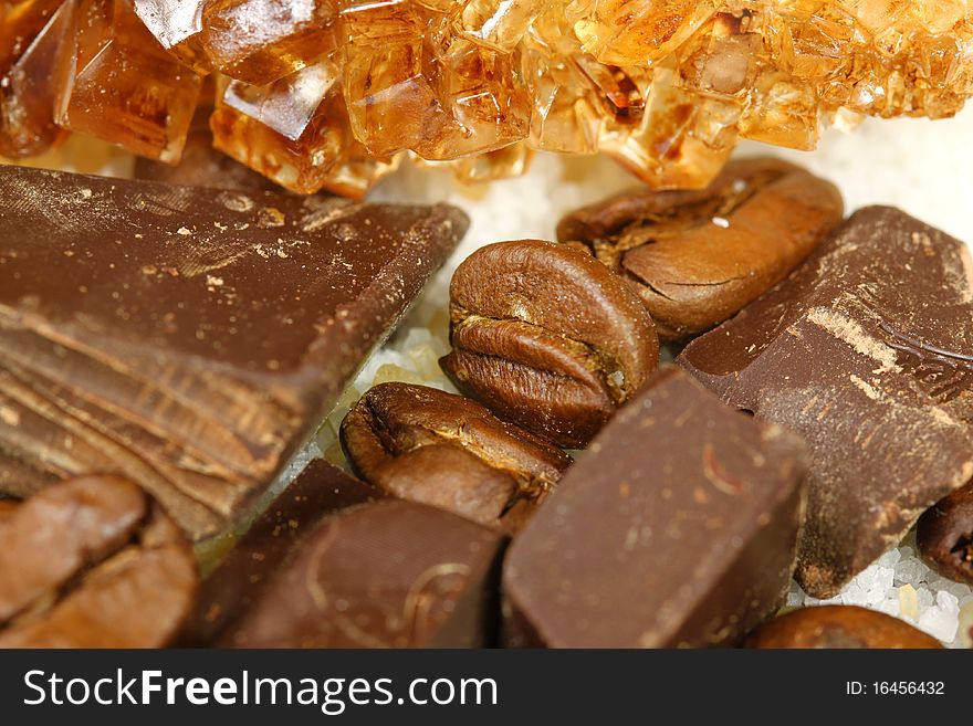 Coffee beans, chocolate bars and caramelized sugar - close up. Coffee beans, chocolate bars and caramelized sugar - close up