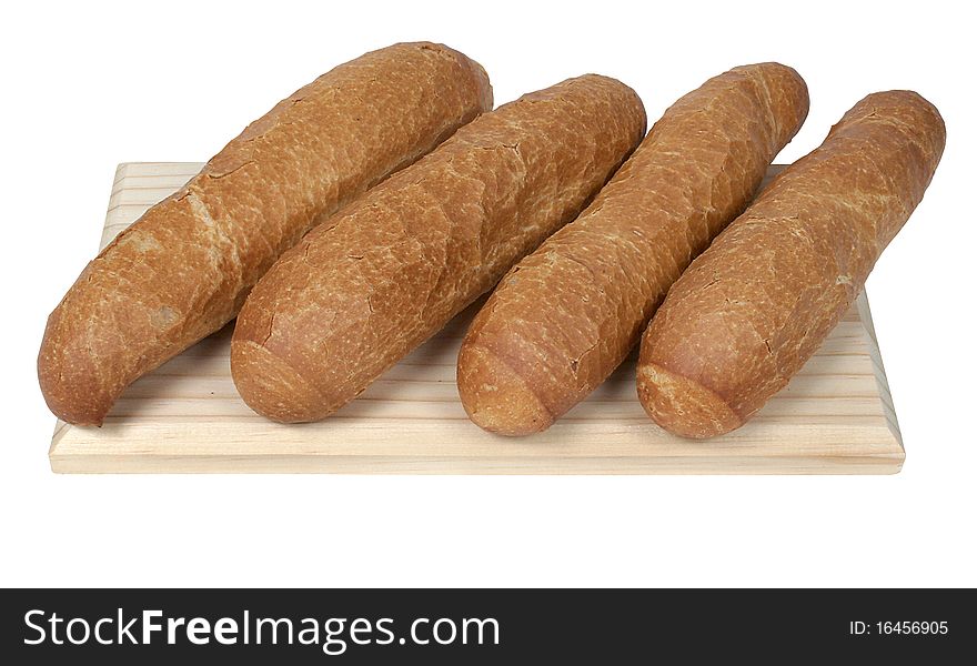 Image of four loaves of freshly baked, crispy bread on a wooden chopping board. Clipping path included. Image of four loaves of freshly baked, crispy bread on a wooden chopping board. Clipping path included.