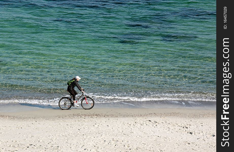 Woman near the sea ride bicycle. Woman near the sea ride bicycle