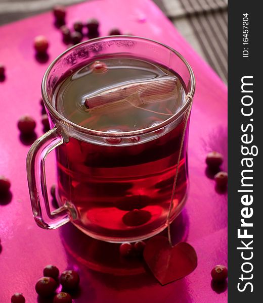 Hot fruit tea with cinnamon in glass cup