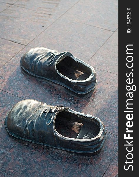 Steel boots on a granite square in the city