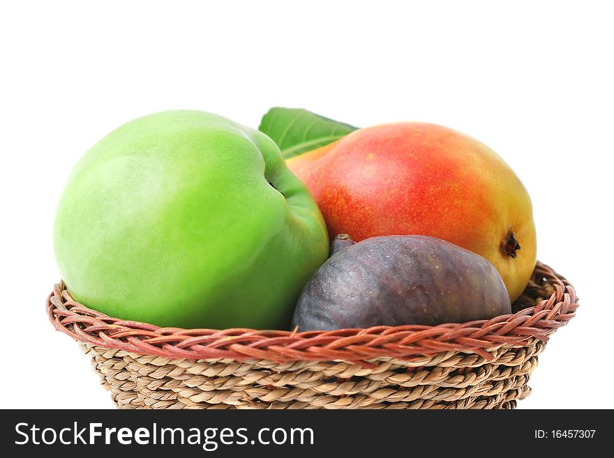 Fresh delicious fruits in the basket isolated on white. Fresh delicious fruits in the basket isolated on white