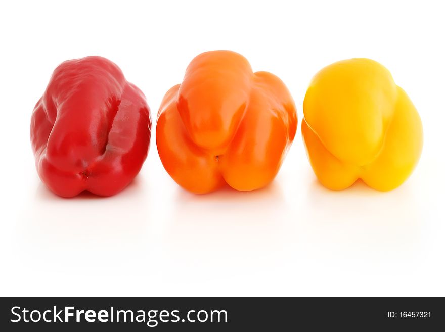 Fresh appetizing bell peppers of red, orange and yellow colors isolated on white with shadow. Fresh appetizing bell peppers of red, orange and yellow colors isolated on white with shadow