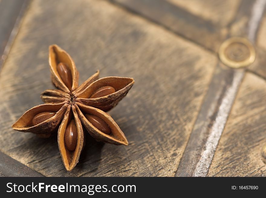 One anice star on an old wood background. Shallow dof. One anice star on an old wood background. Shallow dof.