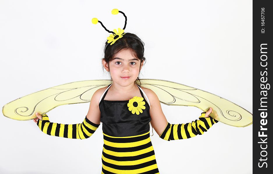 Cute Little girl wearing a bee costume on white background. Cute Little girl wearing a bee costume on white background.